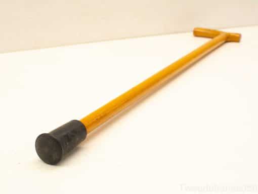 Elegant wooden cane with T-handle and rubber tip for support and style.