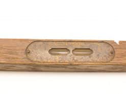 Vintage wooden level with glass vials and aged metal backing, showcasing craftsmanship and history.