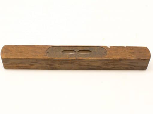 Antique wooden spirit level with brass strip, perfect for collectors and woodworking enthusiasts.