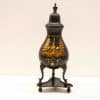 Elegant black urn featuring a stunning golden landscape design, ideal for decoration or collection.