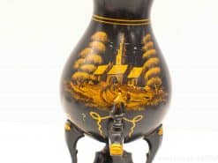 Elegant vintage vase featuring a tranquil landscape painting and robust black stand.