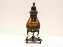 Elegant black urn featuring a stunning golden landscape design, ideal for decoration or collection.