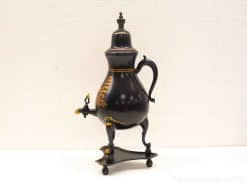 Elegant antique teapot with gold accents, blending functionality and timeless sophistication.