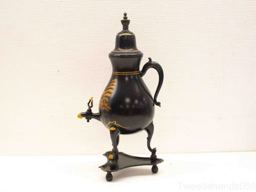Elegant antique teapot with gold accents, blending functionality and timeless sophistication.