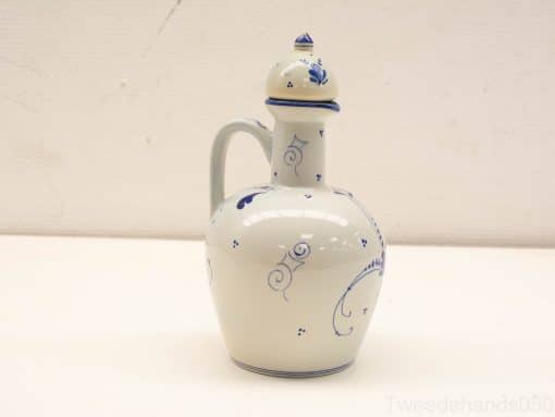 Elegant blue and white ceramic pitcher with intricate designs, perfect for decoration or utility.
