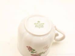 Elegant J. L. Menau porcelain mug from West Germany with hand-painted floral design.