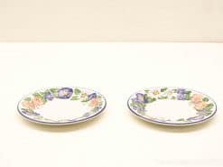 Charming decorative plates with vibrant floral designs, perfect for elegant dining or display.
