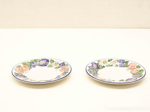 Charming decorative plates with vibrant floral designs, perfect for elegant dining or display.