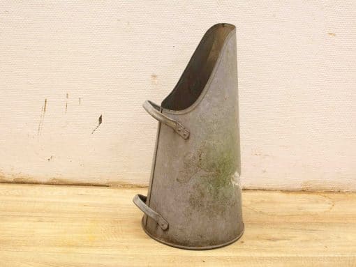 Vintage metal container with rustic charm, perfect for watering or decorative purposes.