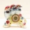 Vibrant ceramic clock featuring three detailed birds and floral motifs for decorative charm.