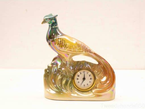 Elegant ceramic pheasant clock with iridescent colors, perfect for decorative home styling.