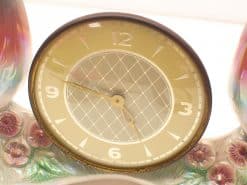 Elegant vintage clock with floral motifs and iridescent vases for stylish home decor.