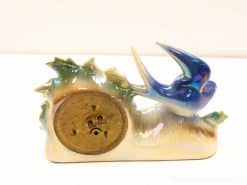 Elegant decorative telephone featuring a swallow and organic shapes in soft pastel colors.