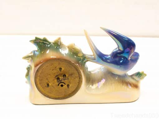 Elegant decorative telephone featuring a swallow and organic shapes in soft pastel colors.