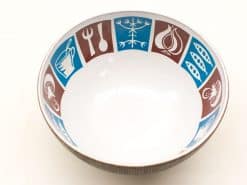 Charming ceramic bowl with vibrant geometric patterns, perfect for modern kitchens and festive dining.