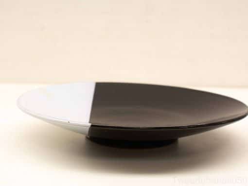 Stylish black and white serving plate, perfect for contemporary dining and decor.