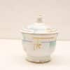 Elegant porcelain container with lid and gold accents, perfect for decorative displays and accents.