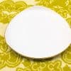 Elegant white plate with a golden rim, perfect for stylish dining or decorative use.