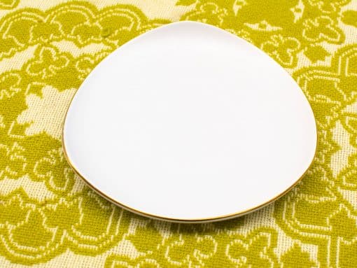 Elegant white plate with a golden rim, perfect for stylish dining or decorative use.