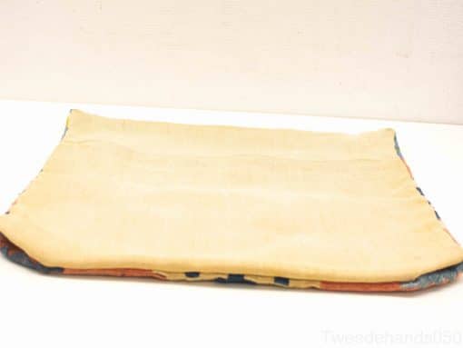 Cozy cream blanket with unique pattern and contrasting edges, perfect for warmth and style.