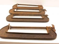 Rustic vintage C-clamps set of 4 for woodworking and metalworking enthusiasts.