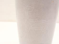 Elegant minimalist vase with embossed deer design, perfect for decor or unique floral displays.
