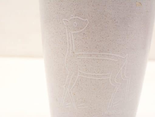 Elegant minimalist vase with embossed deer design, perfect for decor or unique floral displays.