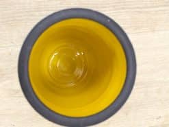 Two-tone mug with a cheerful yellow interior and a sleek dark rim.