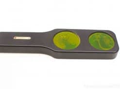 Vintage geological specimen viewer with dual lenses showcasing vibrant green mineral textures.