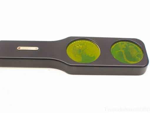 Vintage geological specimen viewer with dual lenses showcasing vibrant green mineral textures.