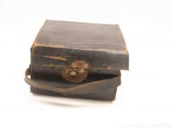 Vintage leather case with brass latch and handle, perfect for storage or as decor.