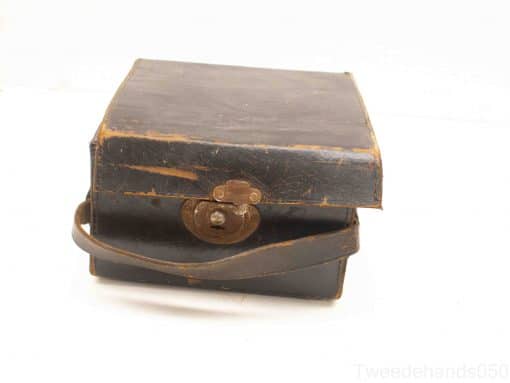 Vintage leather case with brass latch and handle, perfect for storage or as decor.