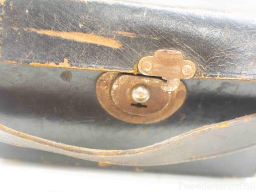 Vintage leather bag with rustic lock, showcasing unique character and craftsmanship.