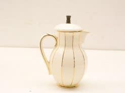 Elegant porcelain coffee pitcher with gold stripes, perfect for table decor and collection.