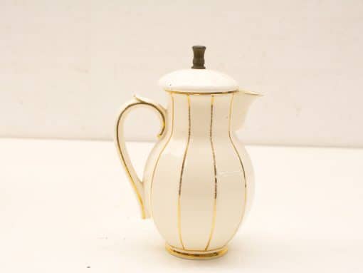 Elegant porcelain coffee pitcher with gold stripes, perfect for table decor and collection.