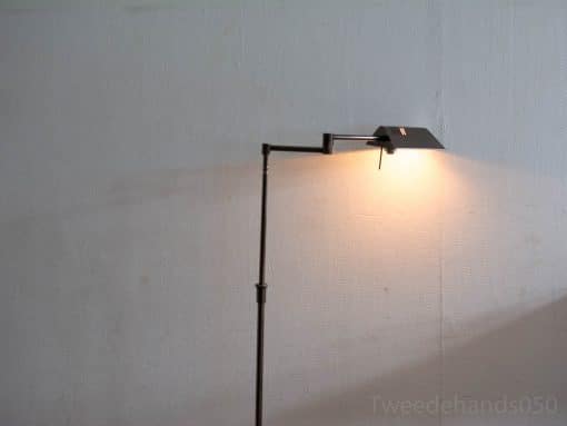Modern adjustable floor lamp with warm light for a cozy, contemporary living space.