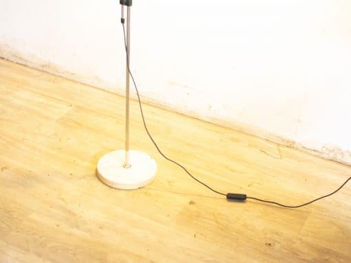 Sleek metal floor lamp with stable base, perfect for modern living spaces and functionality.