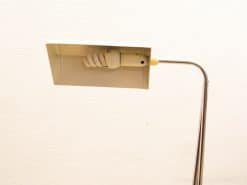 Sleek, modern metal table lamp with a rectangular off-white shade for elegant ambiance.