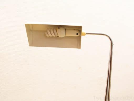 Sleek, modern metal table lamp with a rectangular off-white shade for elegant ambiance.