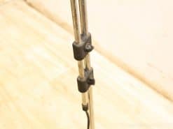 Adjustable stainless steel stand for lighting or microphone, featuring rubber grips for stability.