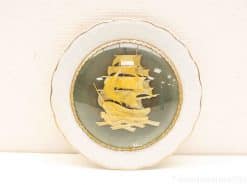 Elegant sailing ship decorative plate with gold accents and nautical theme, perfect for collectors.