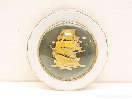 Elegant sailing ship decorative plate with gold accents and nautical theme, perfect for collectors.