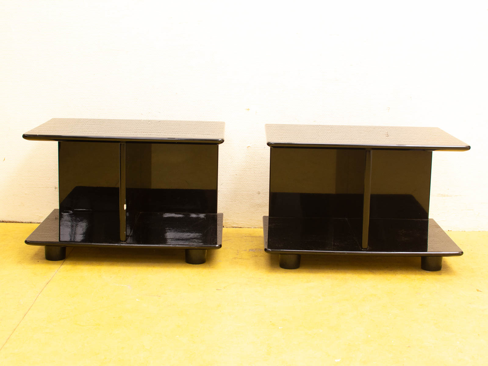 Stylish modern black side tables with glossy finishes, perfect for contemporary living spaces.