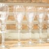 Elegant crystal glasses on rustic wood, perfect for celebrations and special occasions.