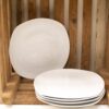 Rustic wooden crate with elegant white plates, blending charm and modern sophistication for stylish storage.