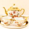 Elegant vintage tea set with dragon motif and gold accents, perfect for collectors and tea lovers.