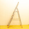 Stylish aluminum step ladder with red edges, ideal for home improvement and safe access.