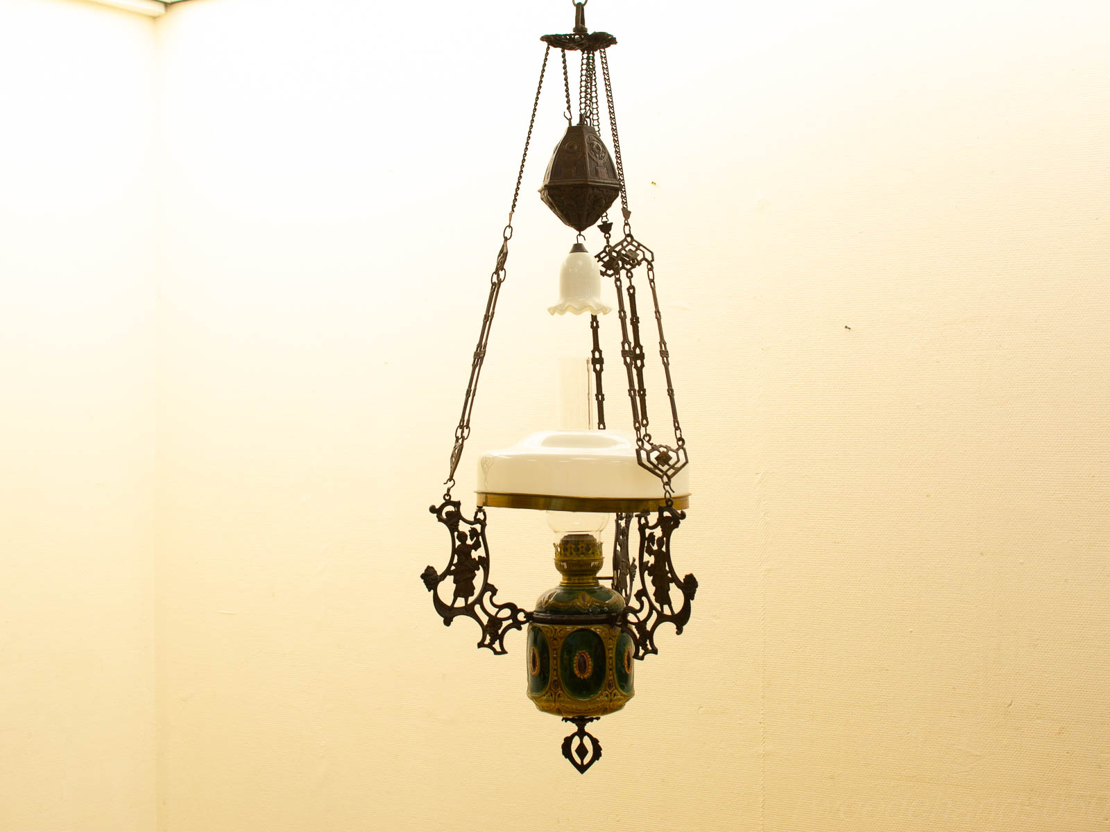 Antique hanging lamp with vibrant colors and glass shade, perfect for vintage decor.