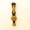 Elegant vintage wooden thermometer-barometer wall decor, combining classic design with functional weather measurements.