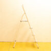 White metal step ladder in a cheerful yellow workspace, ideal for everyday tasks and repairs.